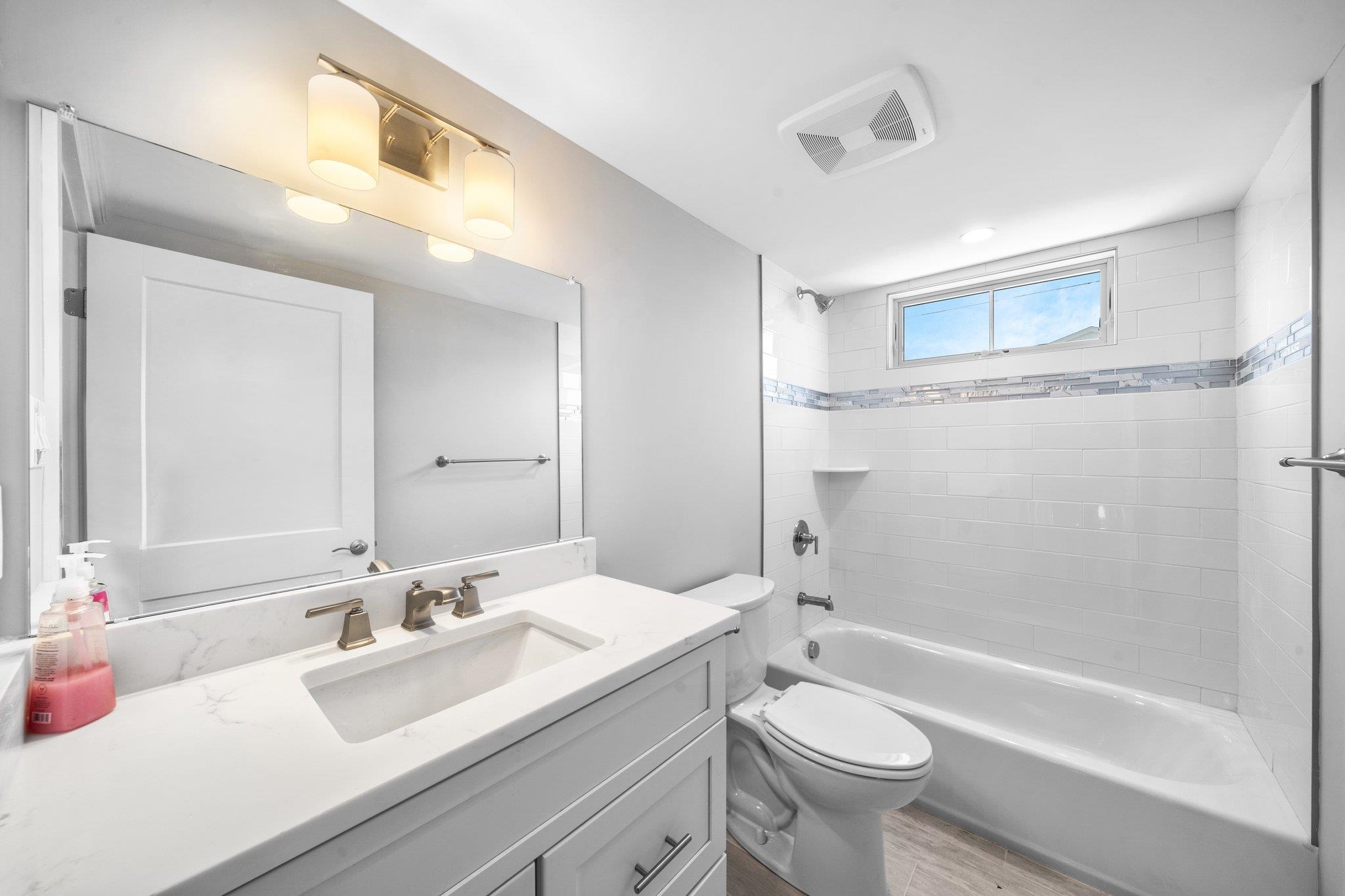 297 24th, Unit 297 Avalon, NJ 08202 - Photo 23 of 49 a bathroom with a sink a toilet and shower