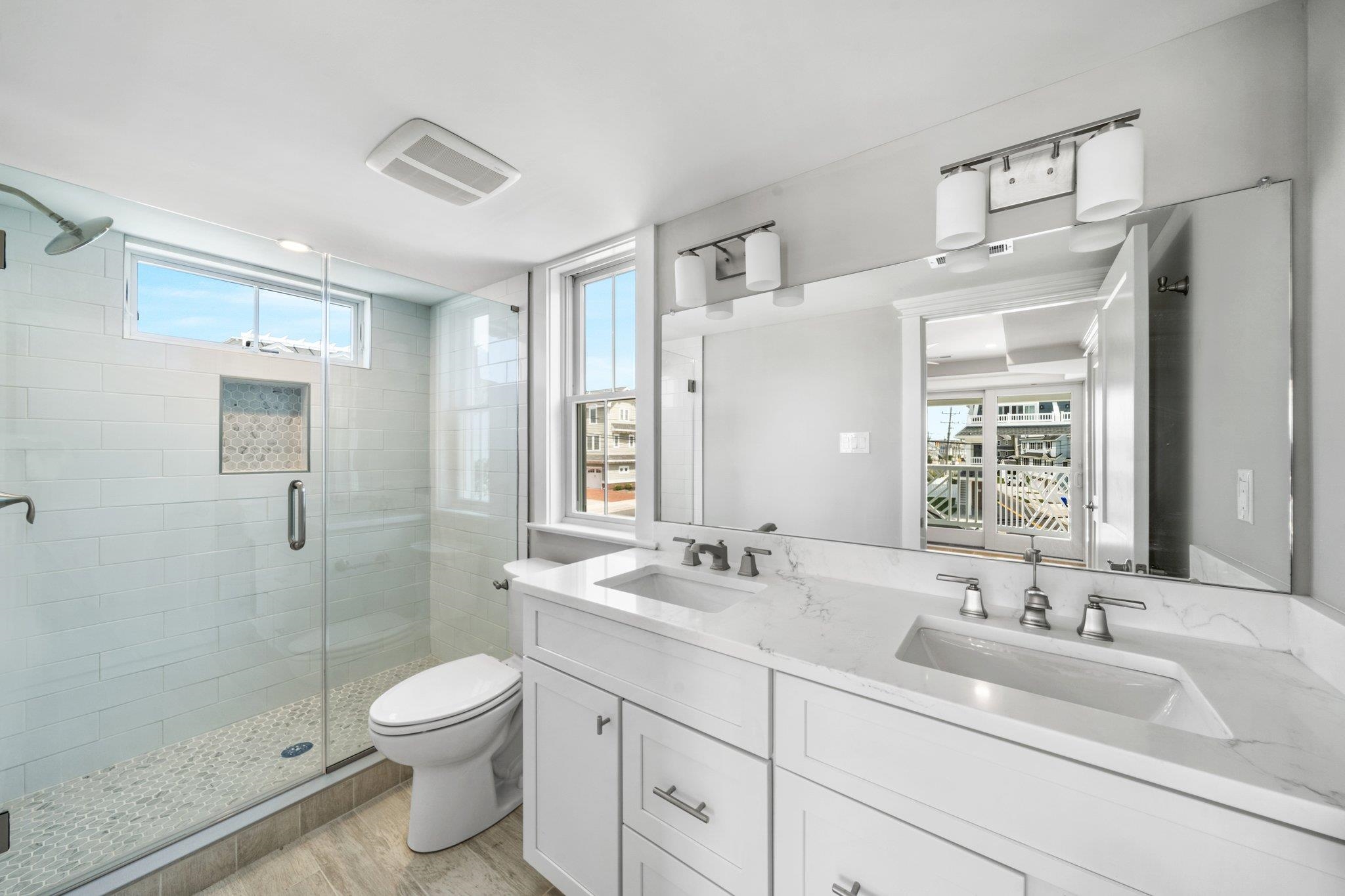 297 24th, Unit 297 Avalon, NJ 08202 - Photo 26 of 49 a bathroom with a sink a toilet and shower