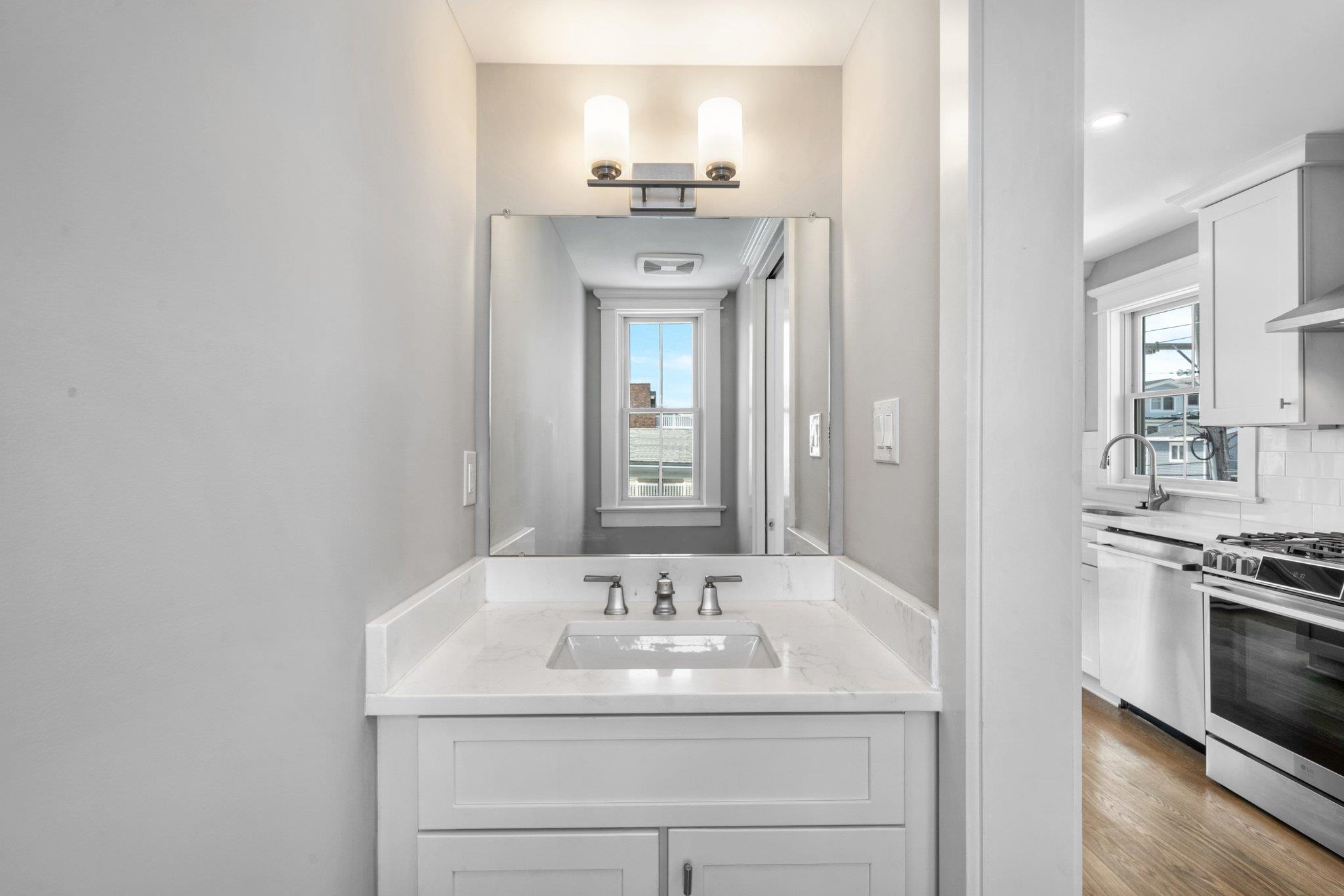 297 24th, Unit 297 Avalon, NJ 08202 - Photo 36 of 49 a bathroom with a sink and a mirror