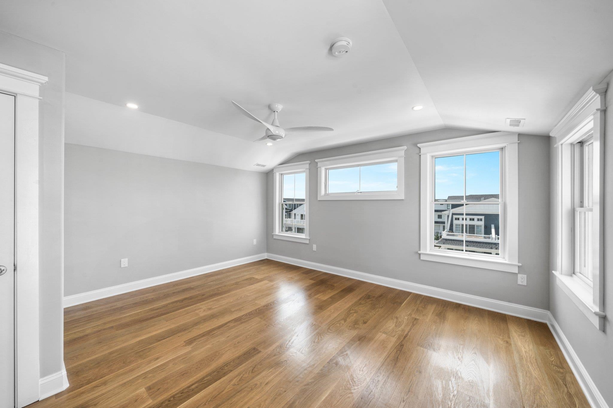 297 24th, Unit 297 Avalon, NJ 08202 - Photo 40 of 49 a view of an empty room with wooden floor and a window