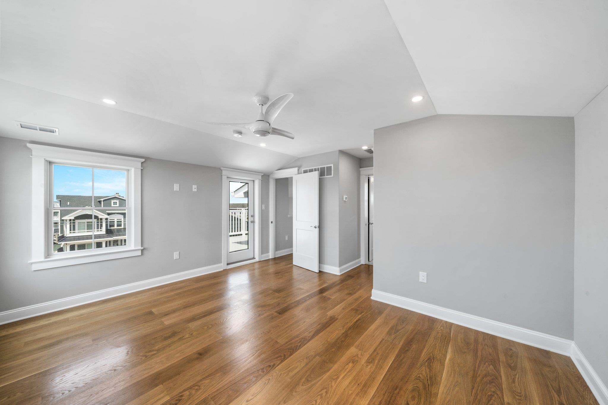 297 24th, Unit 297 Avalon, NJ 08202 - Photo 41 of 49 a view of an empty room with wooden floor and a window