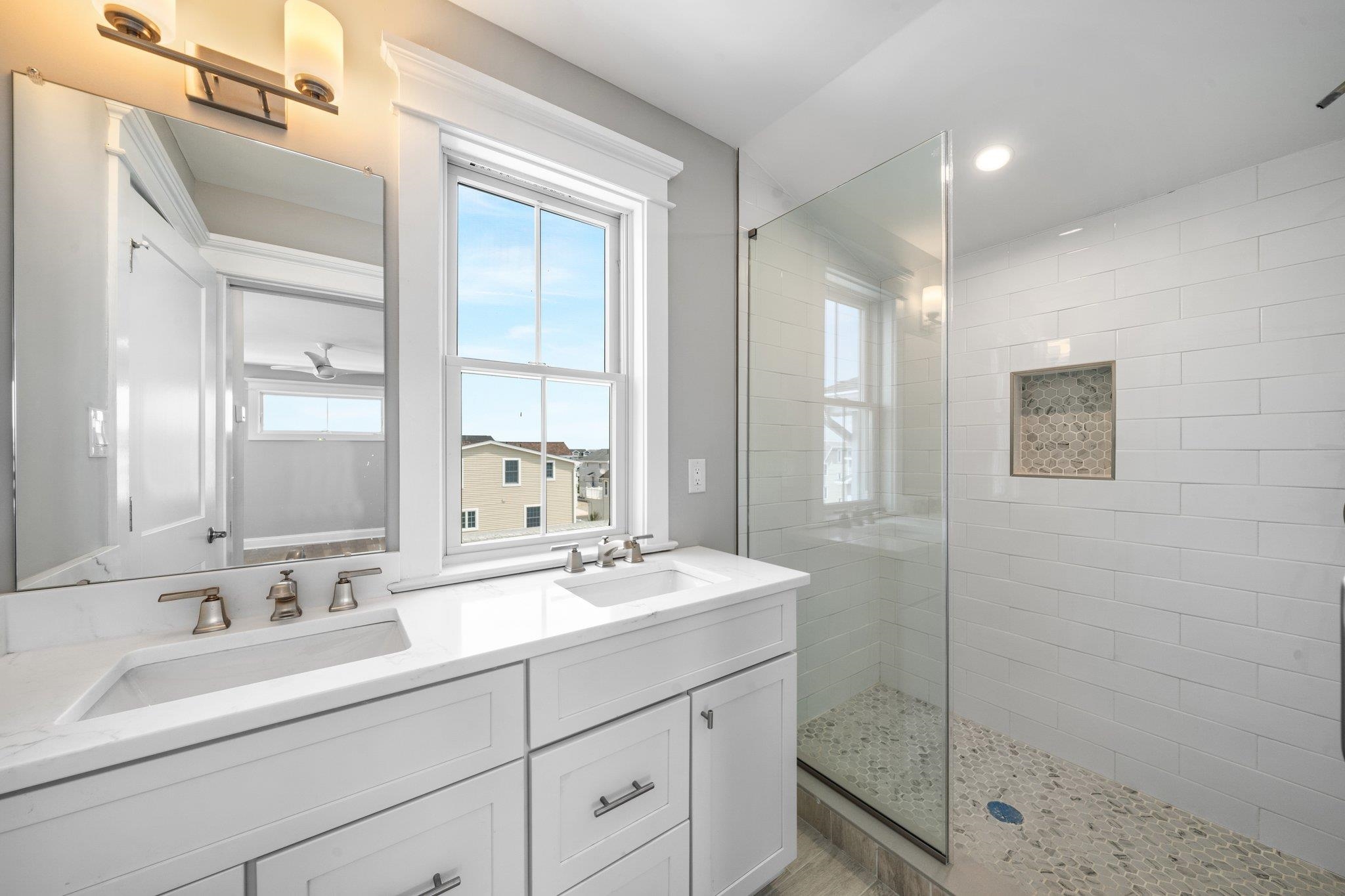 297 24th, Unit 297 Avalon, NJ 08202 - Photo 43 of 49 a bathroom with double sink and a mirror