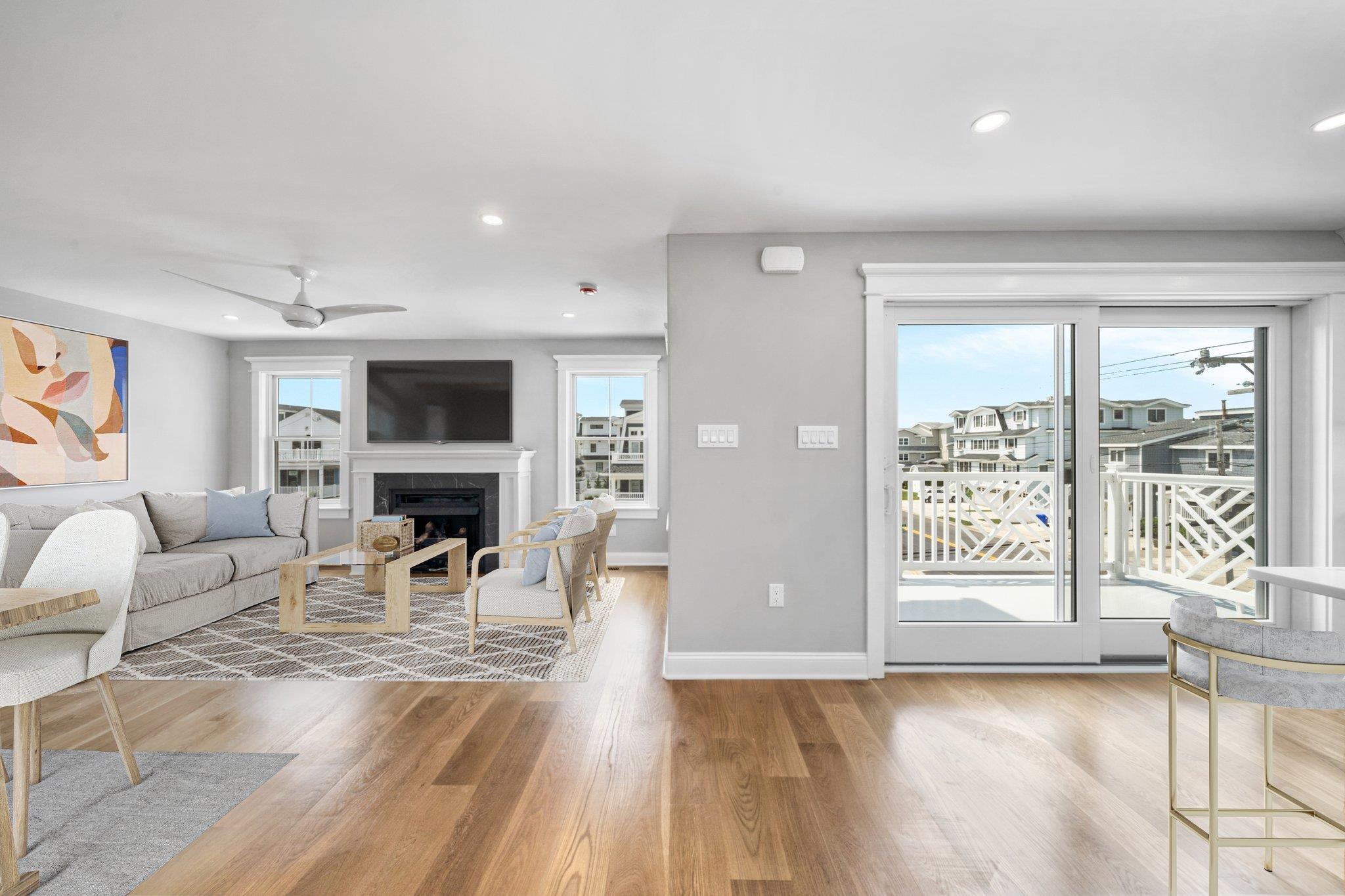 297 24th, Unit 297 Avalon, NJ 08202 - Photo 5 of 49 a living room with furniture a fireplace and a flat screen tv