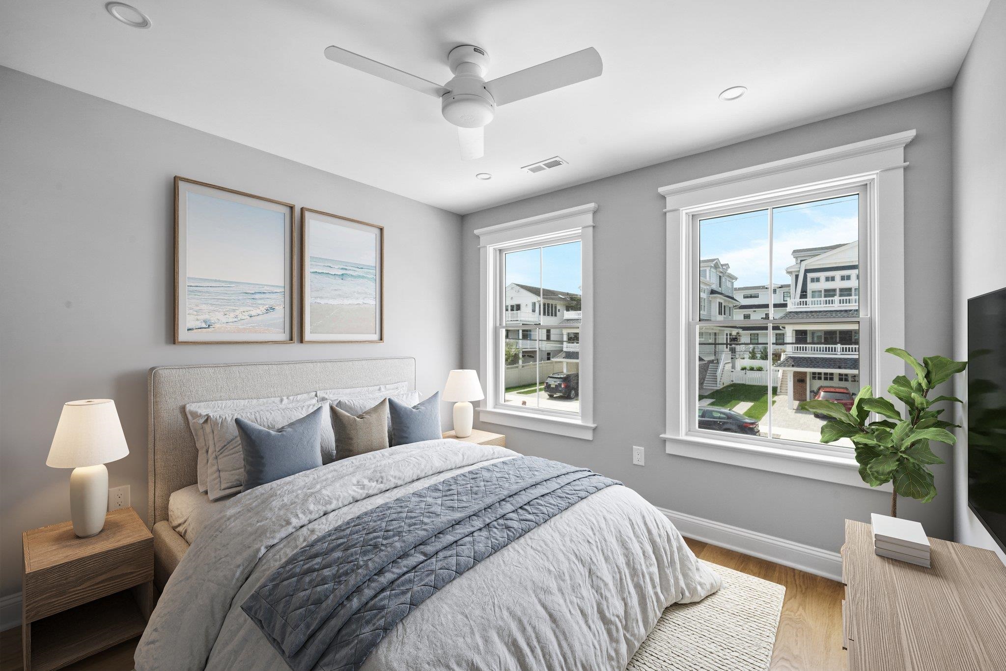 297 24th, Unit 297 Avalon, NJ 08202 - Photo 9 of 49 a bedroom with a large bed and windows