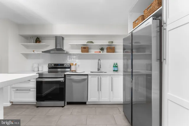 a kitchen with stainless steel appliances granite countertop a sink and a stove