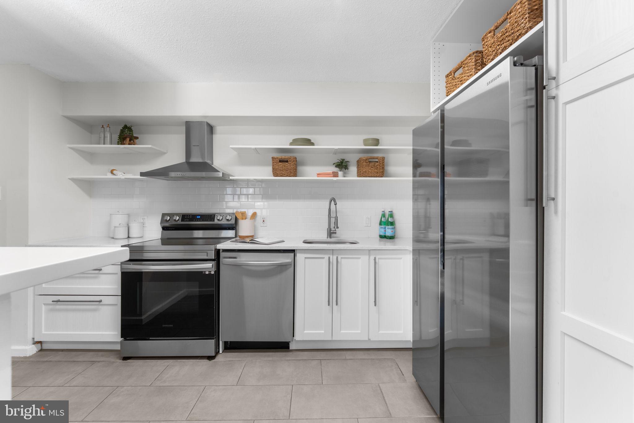 2141 P Street Northwest, Unit 306 Washington, DC 20037 - Photo 11 of 47 a kitchen with stainless steel appliances granite countertop a refrigerator and a stove