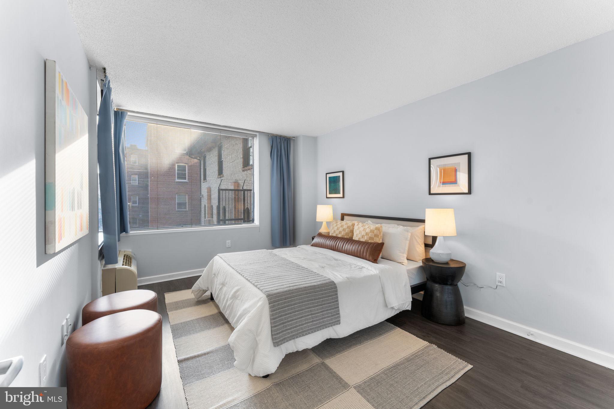 2141 P Street Northwest, Unit 306 Washington, DC 20037 - Photo 18 of 47 a bedroom with a bed and a window