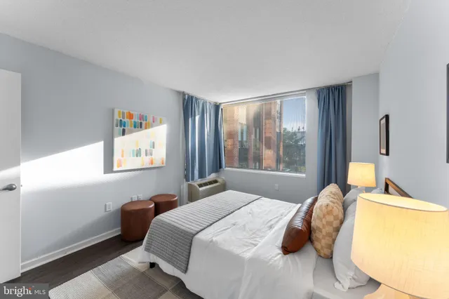 a bedroom with a bed and a lamp on table