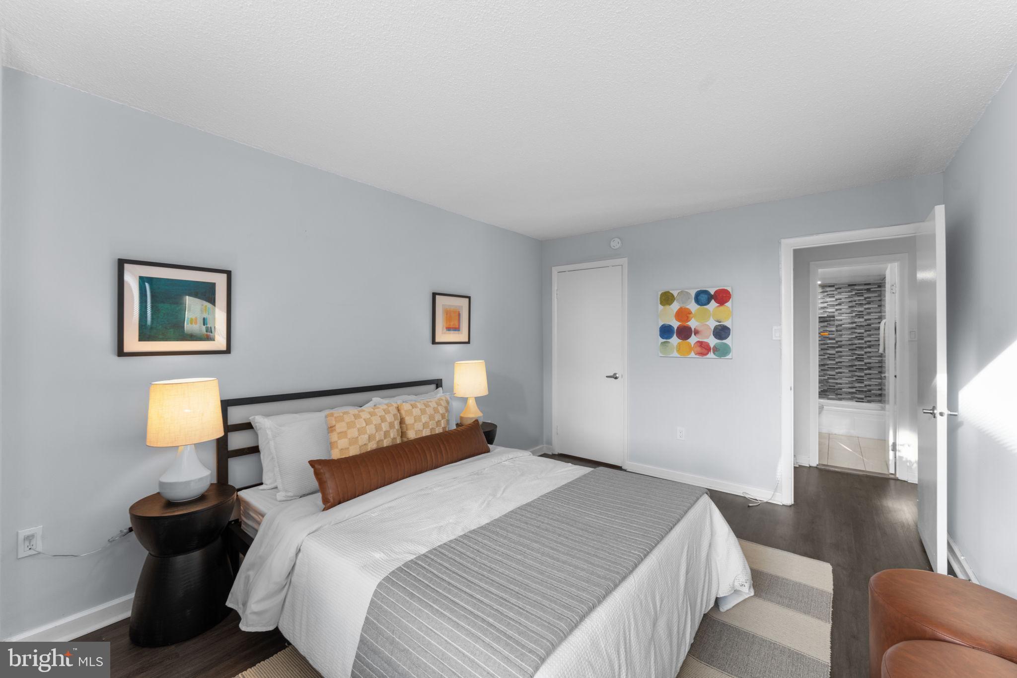 2141 P Street Northwest, Unit 306 Washington, DC 20037 - Photo 20 of 47 a bedroom with a bed and a lamp on table