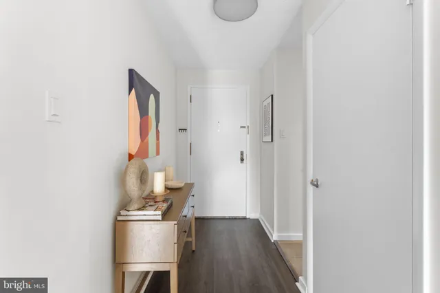 a view of a hallway with workspace and wooden floor