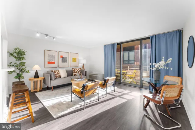 a living room with furniture or couch and a wooden floor