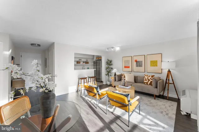 a kitchen with a table chairs refrigerator and cabinets