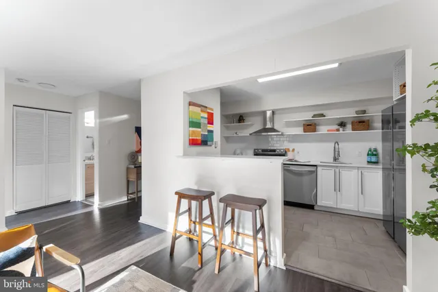 a kitchen with refrigerator and cabinets