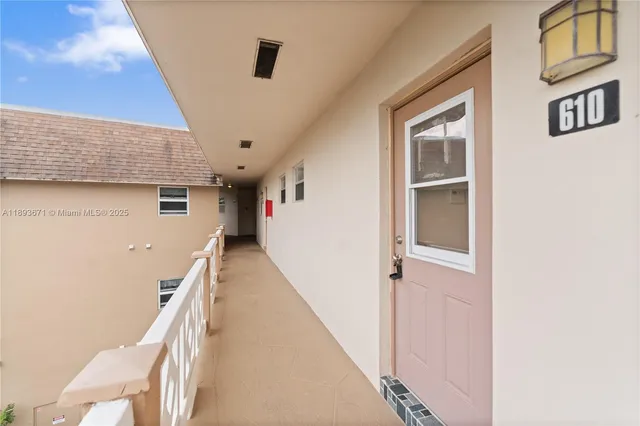 a view of entryway with furniture and front door