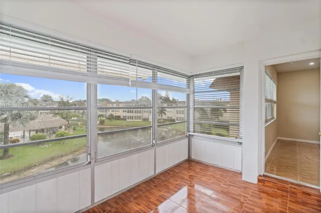 an empty room with a ceiling fan and window