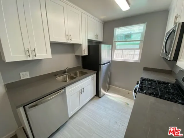 a kitchen with a stove and a refrigerator