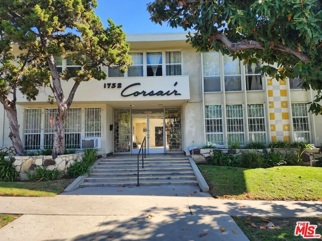 front view of a brick house with a yard