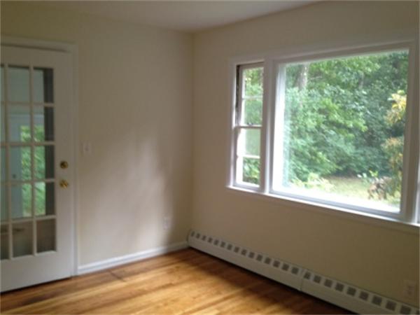 21 Howell Road Sudbury, MA 01776 - Photo 12 of 22 a view of an empty room with wooden floor and a window