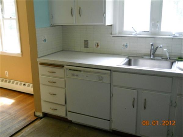 21 Howell Road Sudbury, MA 01776 - Photo 7 of 22 a kitchen with granite countertop white cabinets and a sink
