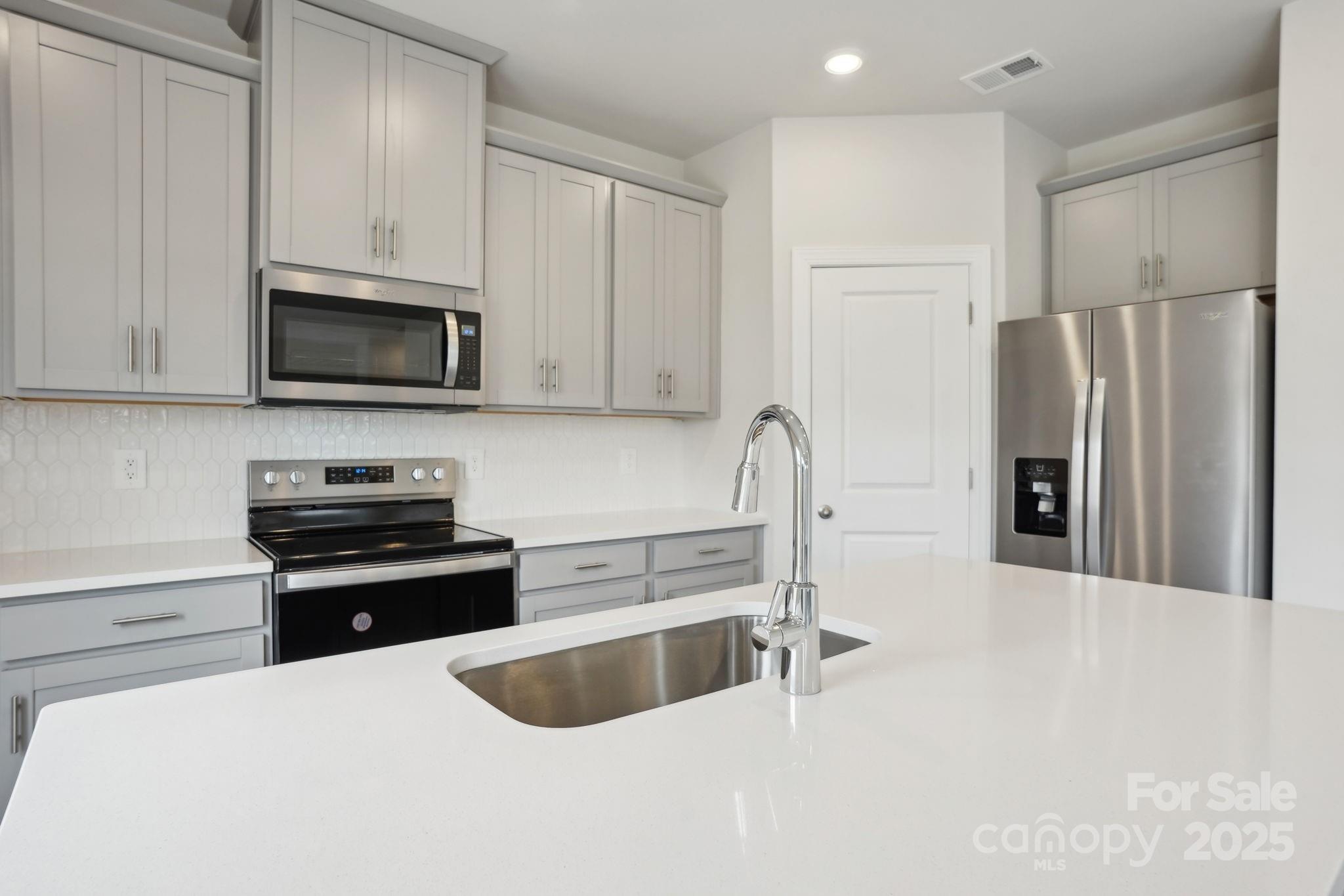 196 Murphy Mdw Road Mocksville, NC 27028 - Photo 11 of 24 a kitchen with stainless steel appliances granite countertop a refrigerator and a sink