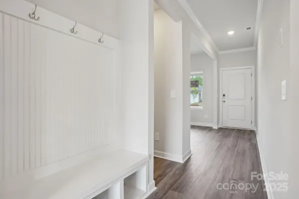 a view of a hallway with wooden floor