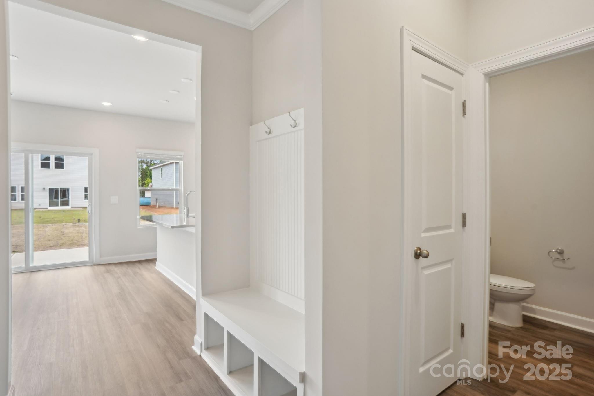 196 Murphy Mdw Road Mocksville, NC 27028 - Photo 4 of 24 a view of a hallway with wooden floor and a bathroom