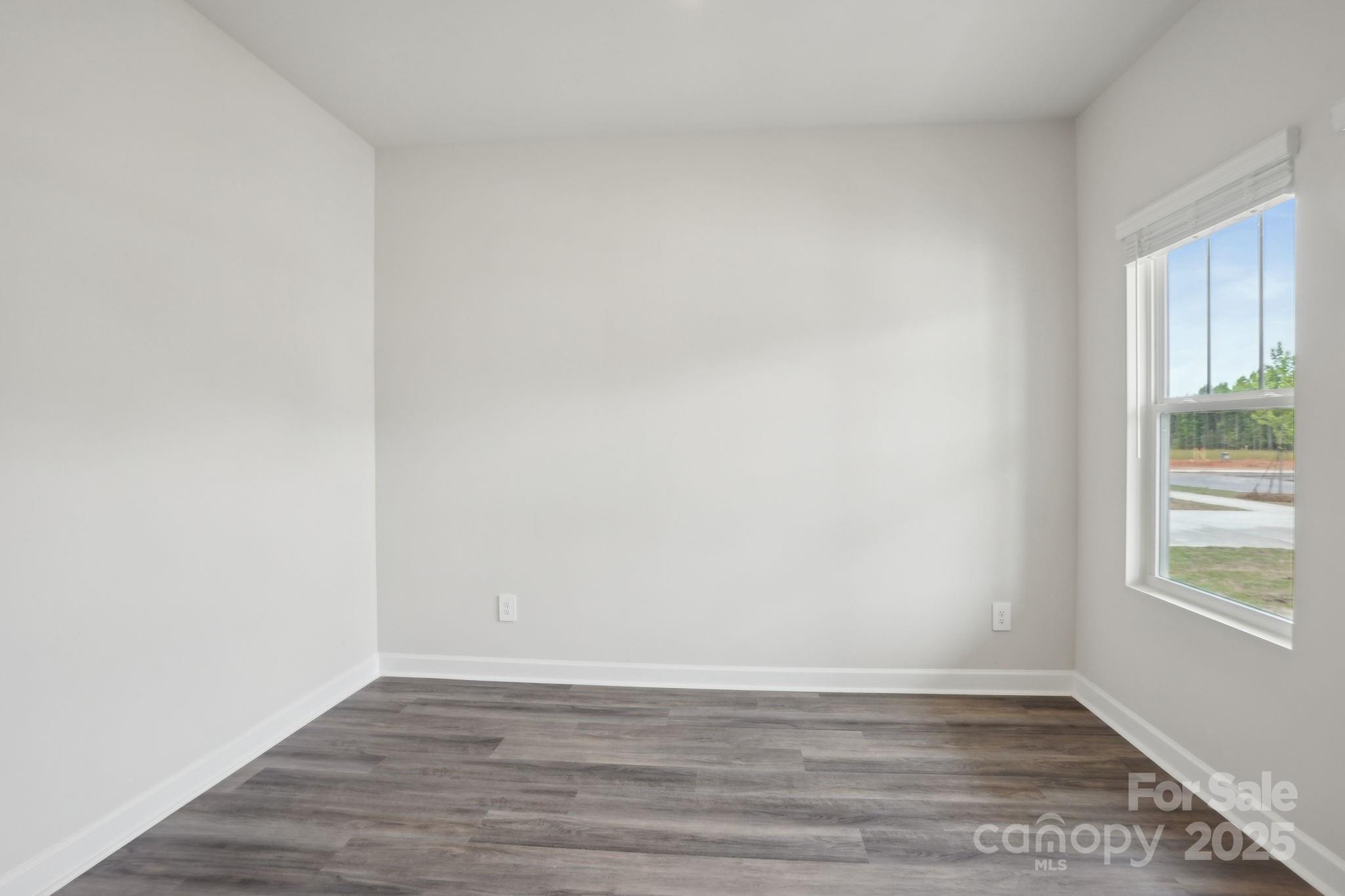 196 Murphy Mdw Road Mocksville, NC 27028 - Photo 5 of 24 a view of an empty room with wooden floor and a window