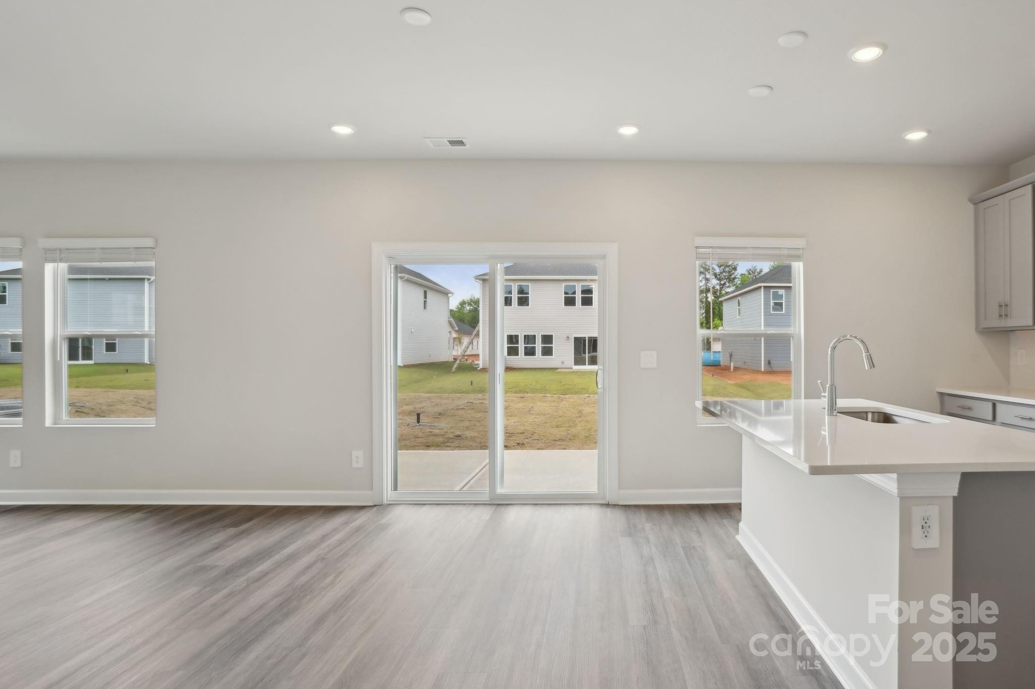 196 Murphy Mdw Road Mocksville, NC 27028 - Photo 9 of 24 a view of an empty room with window and wooden floor