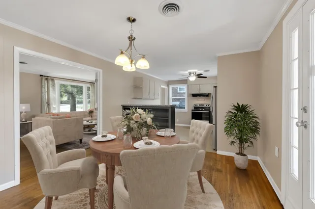 an empty room with wooden floor and a ceiling fan
