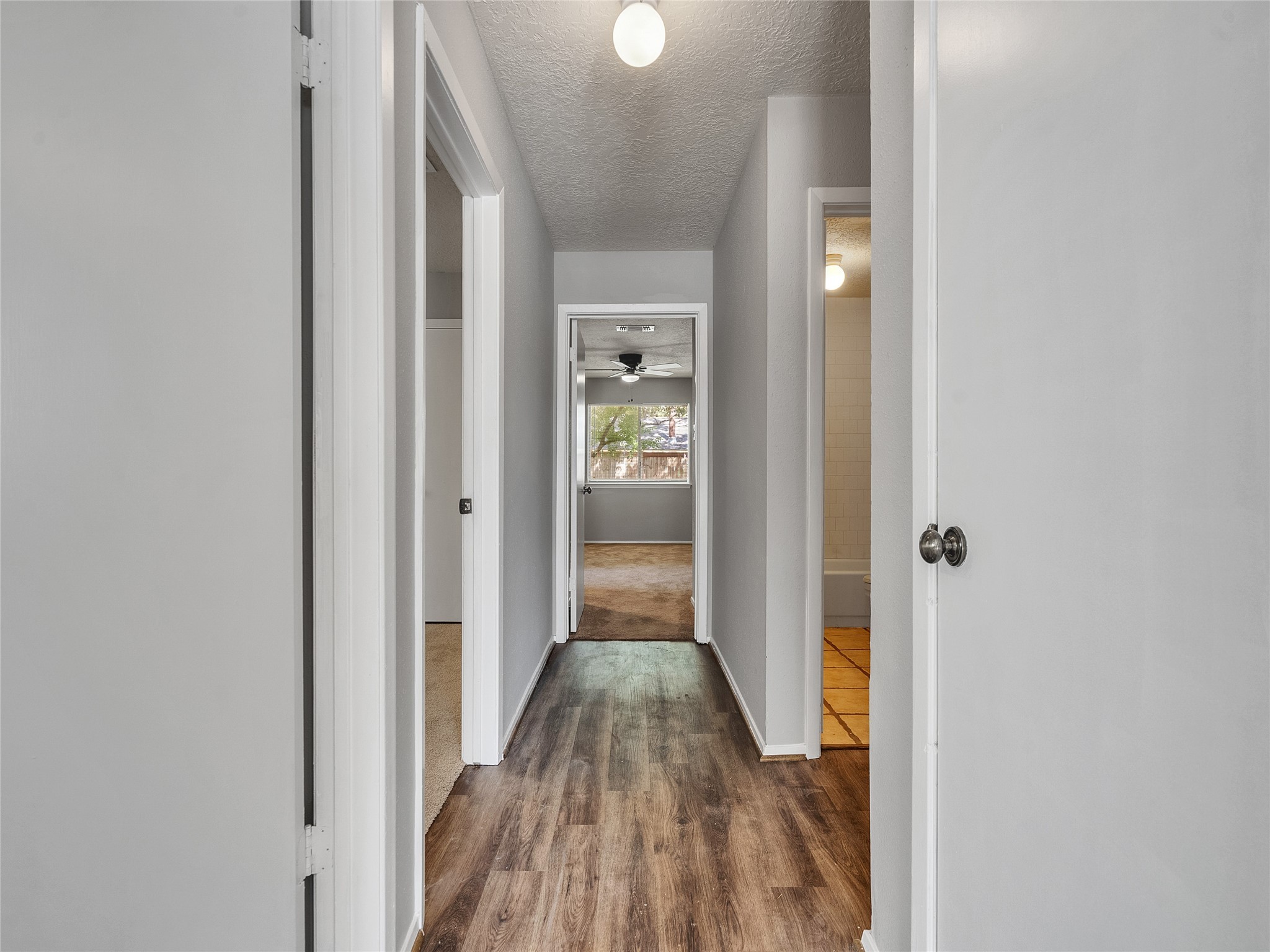 24006 Spring Gum Drive Spring, TX 77373 - Photo 14 of 31 a view of a hallway with wooden floor