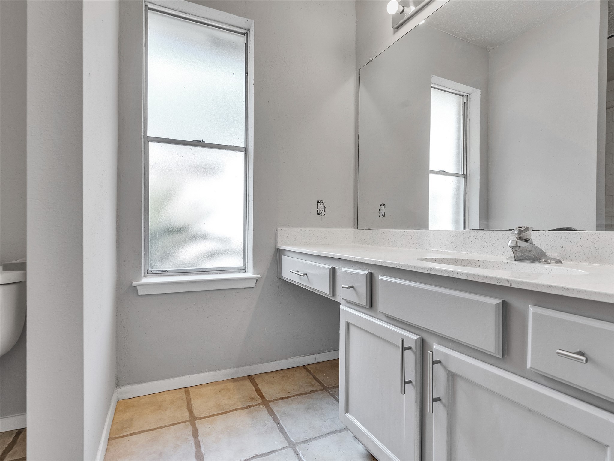 24006 Spring Gum Drive Spring, TX 77373 - Photo 17 of 31 a bathroom with a sink and a mirror