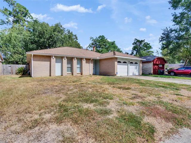 a view of a house with yard and sitting area