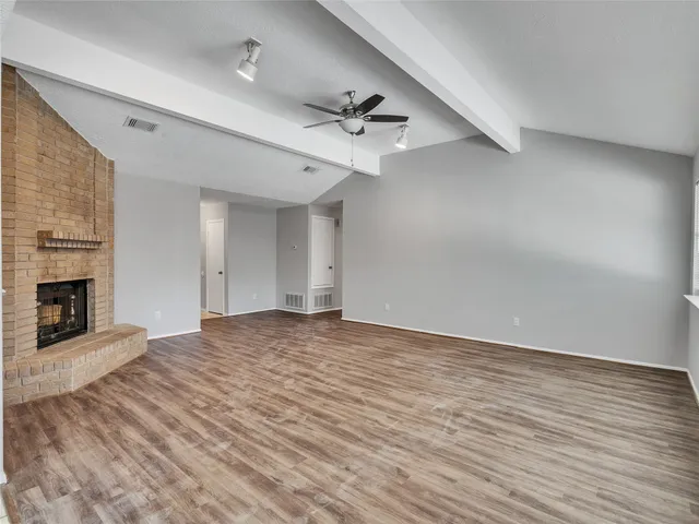 wooden floor in an empty room with a fireplace