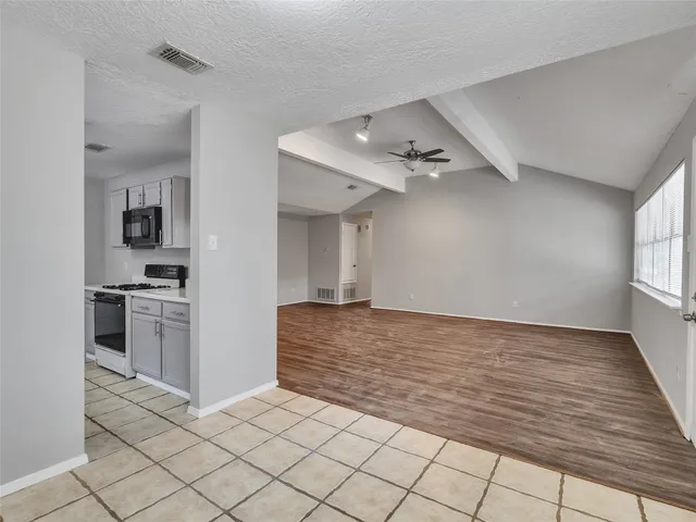 a view of a kitchen with microwave and cabinets