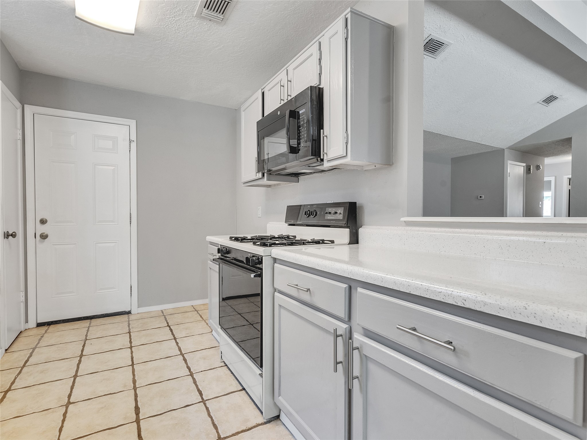 24006 Spring Gum Drive Spring, TX 77373 - Photo 10 of 31 a kitchen with stainless steel appliances a sink stove and cabinets