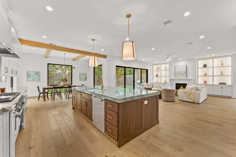 a kitchen with stainless steel appliances granite countertop a stove and more cabinets