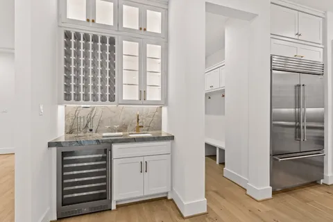 a kitchen with stainless steel appliances cabinets and a wooden floor