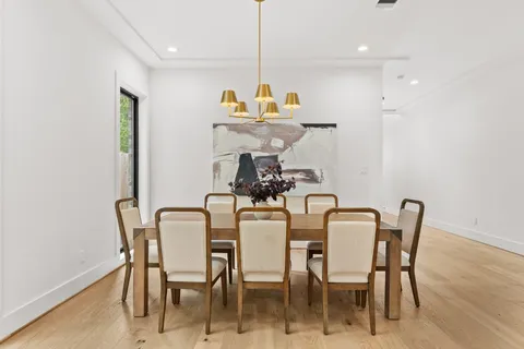 a dining room with furniture and wooden floor