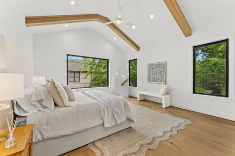 a bedroom with a bed and wooden floor