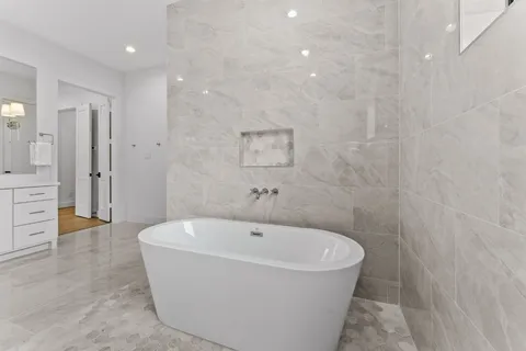a white bath tub sitting in a bathroom