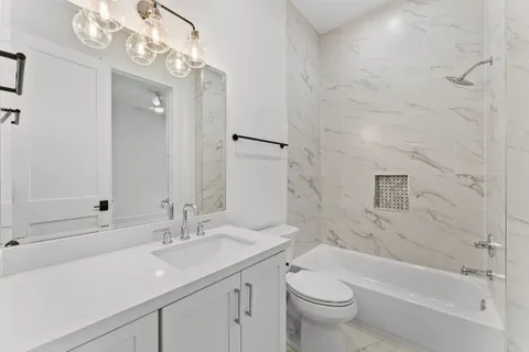 a bathroom with a sink a toilet and a bathtub