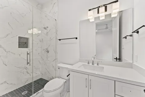 a bathroom with a sink toilet and shower
