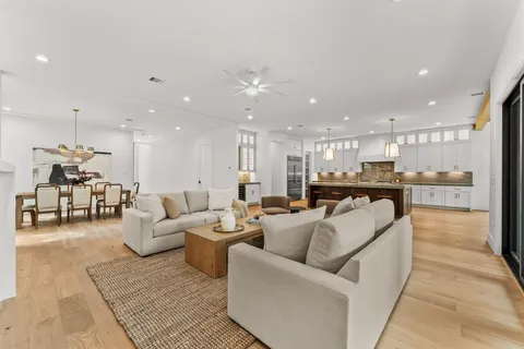 a living room with furniture and kitchen view