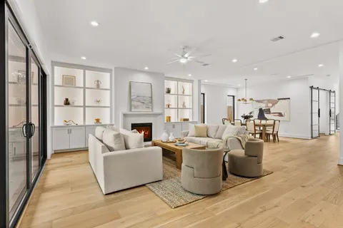 a living room with furniture a fireplace and a chandelier