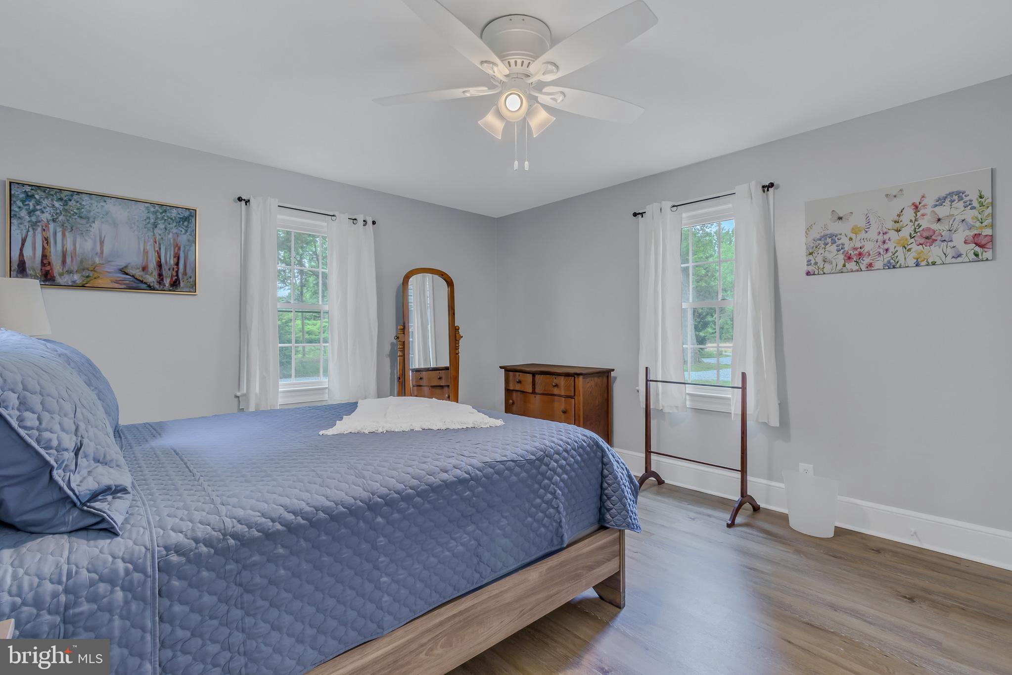 76 Tucker Hill Road Kinsale, VA 22488 - Photo 29 of 43 a bedroom with a large bed and a chandelier