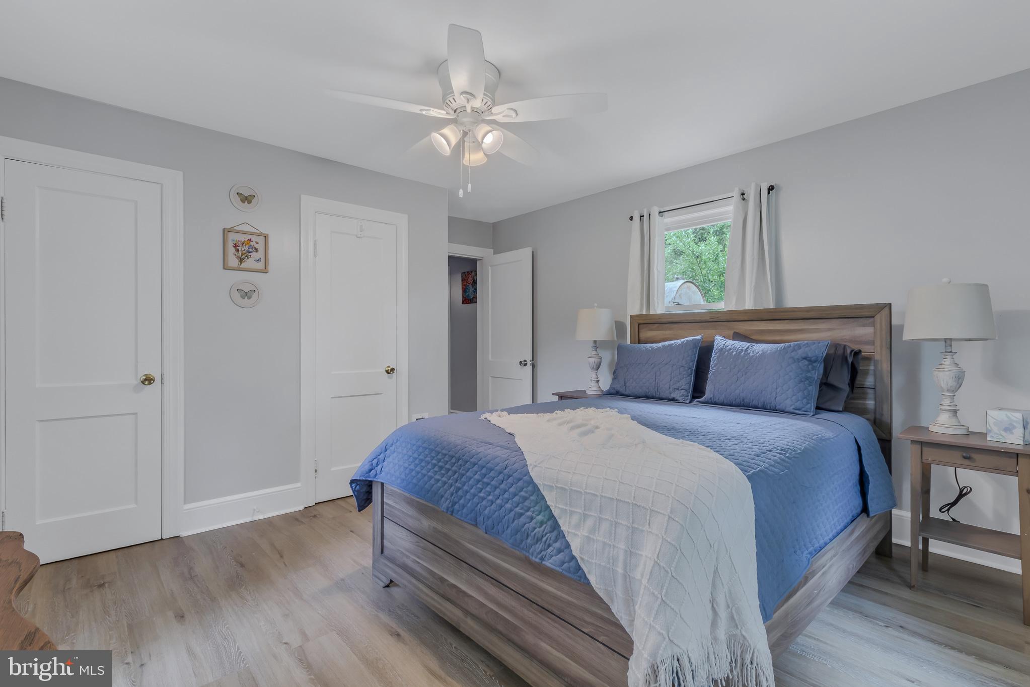 76 Tucker Hill Road Kinsale, VA 22488 - Photo 30 of 43 a bedroom with a bed and a chandelier