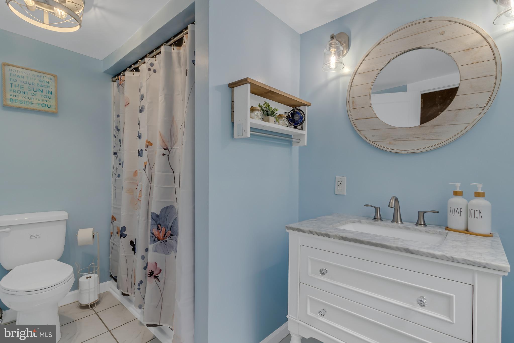 76 Tucker Hill Road Kinsale, VA 22488 - Photo 31 of 43 a bathroom with a granite countertop toilet sink and mirror