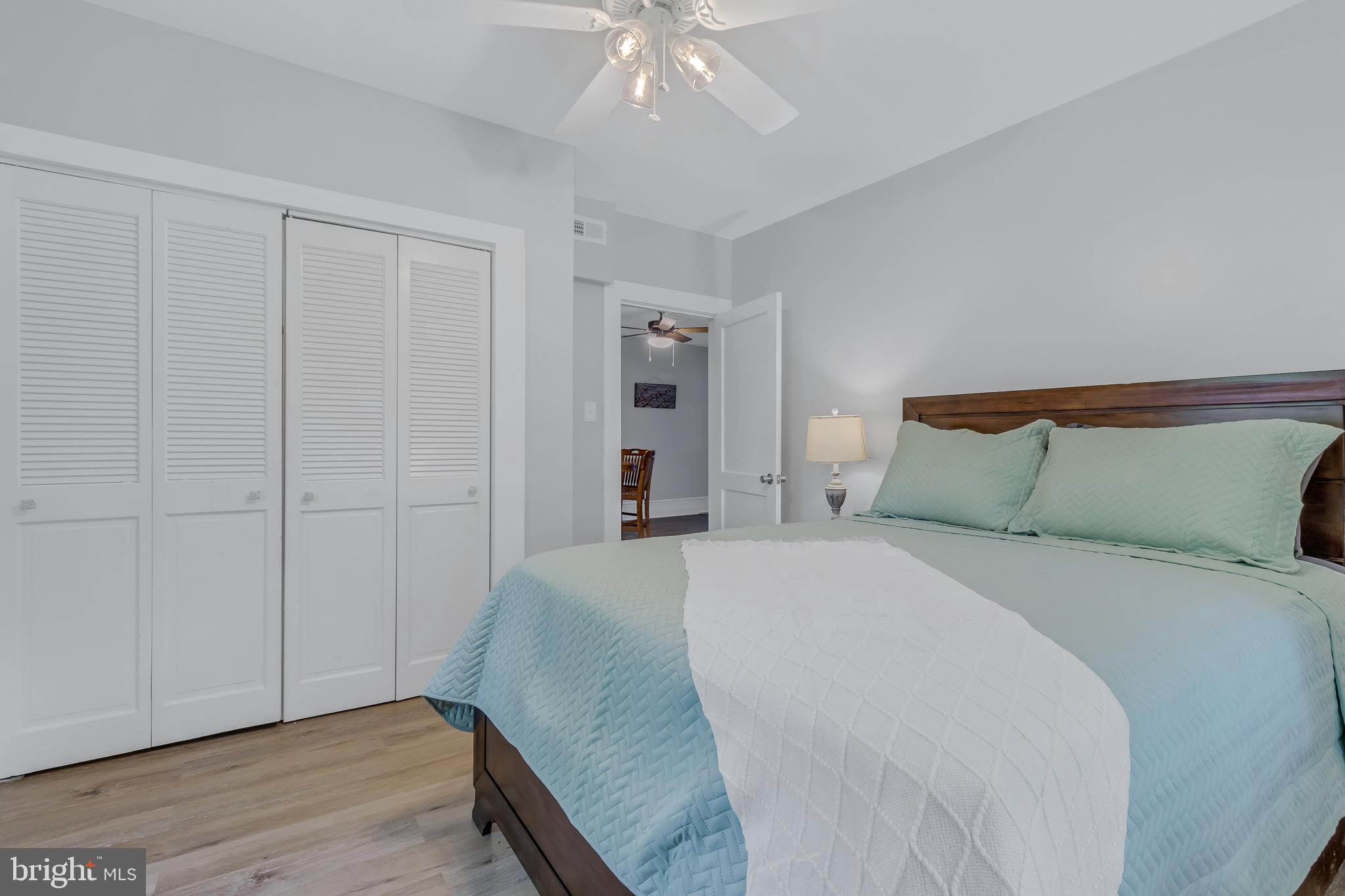 76 Tucker Hill Road Kinsale, VA 22488 - Photo 33 of 43 a spacious bedroom with a bed and a chandelier