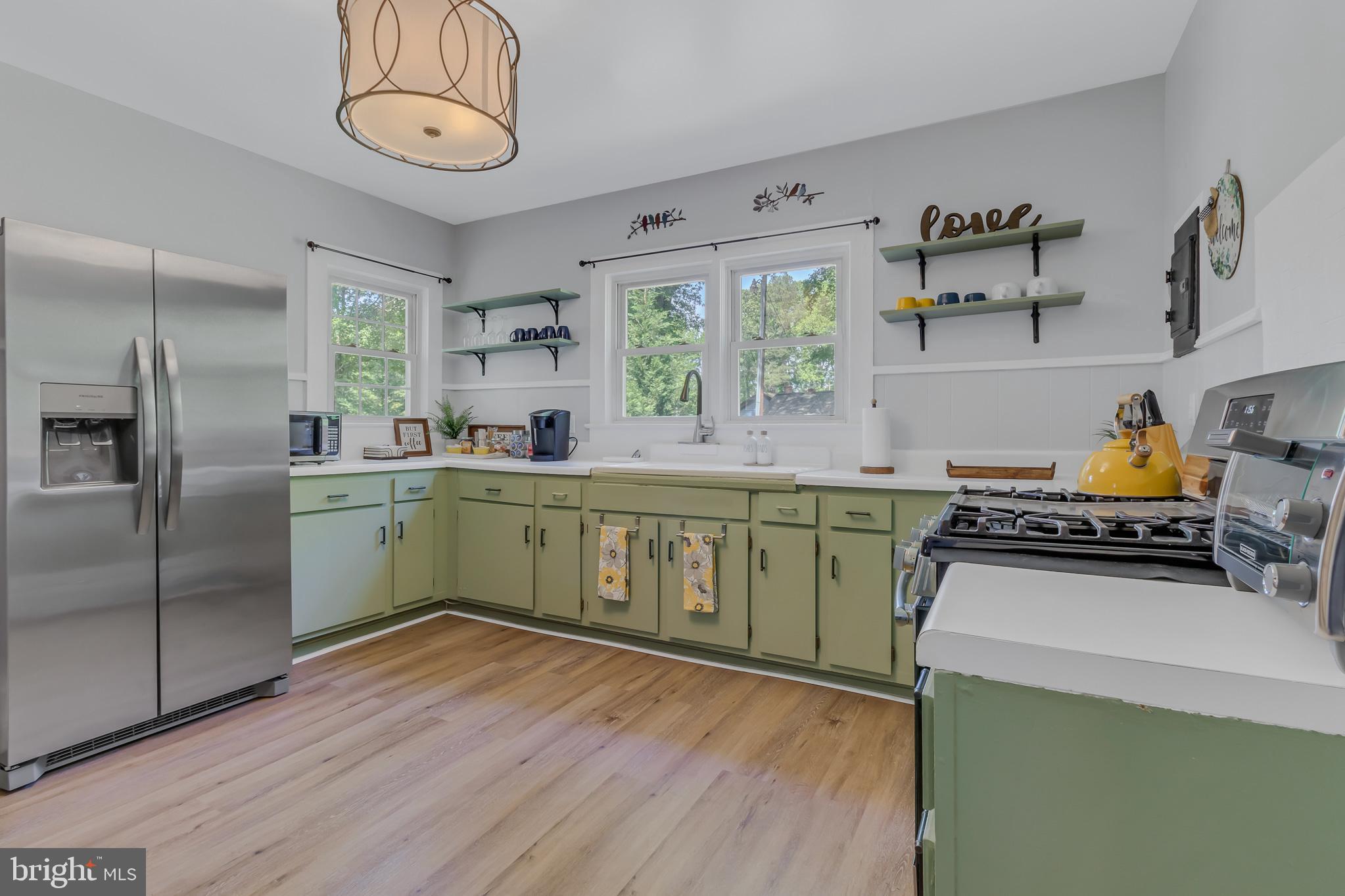 76 Tucker Hill Road Kinsale, VA 22488 - Photo 35 of 43 a kitchen with a stove a sink and a refrigerator