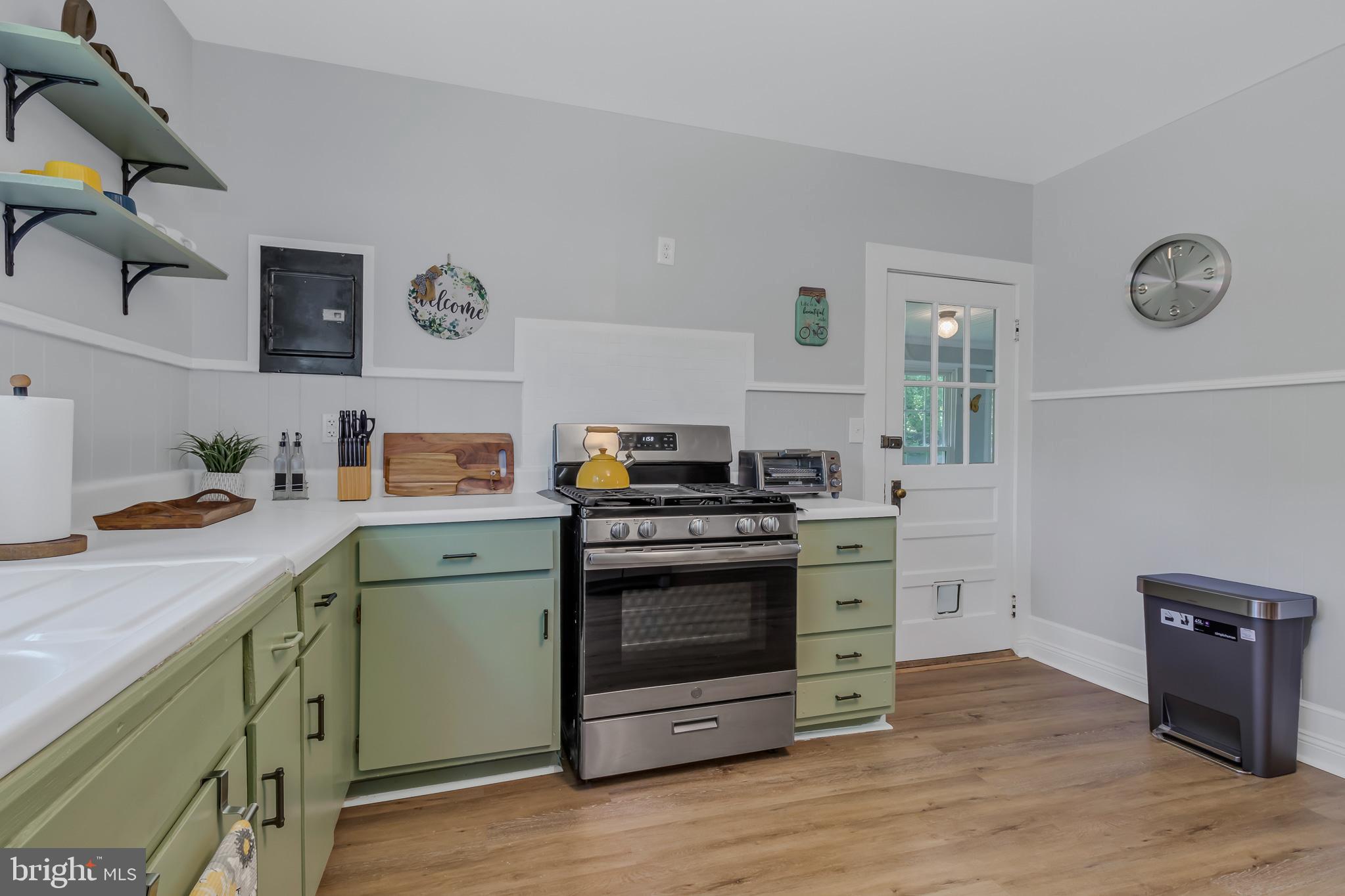 76 Tucker Hill Road Kinsale, VA 22488 - Photo 36 of 43 a kitchen with a stove and a wooden floor